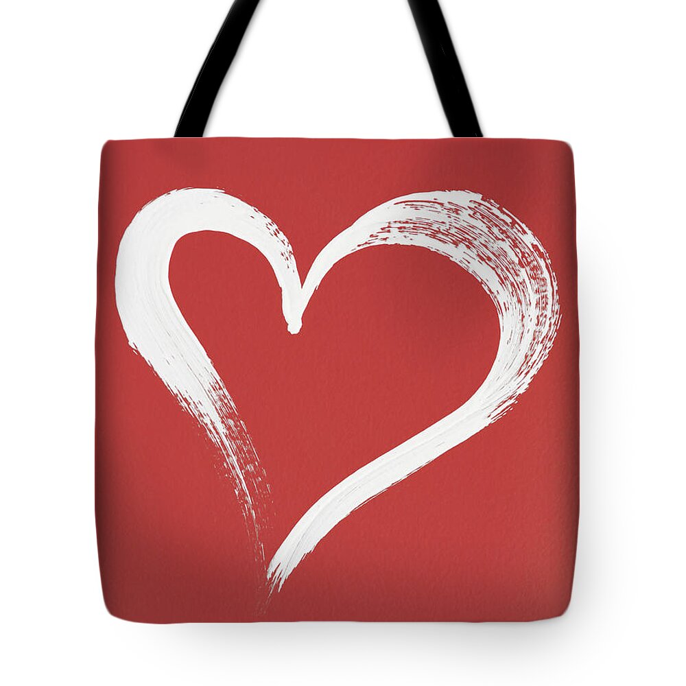 White Tote Bag featuring the photograph White heart painted on red background #1 by GoodMood Art