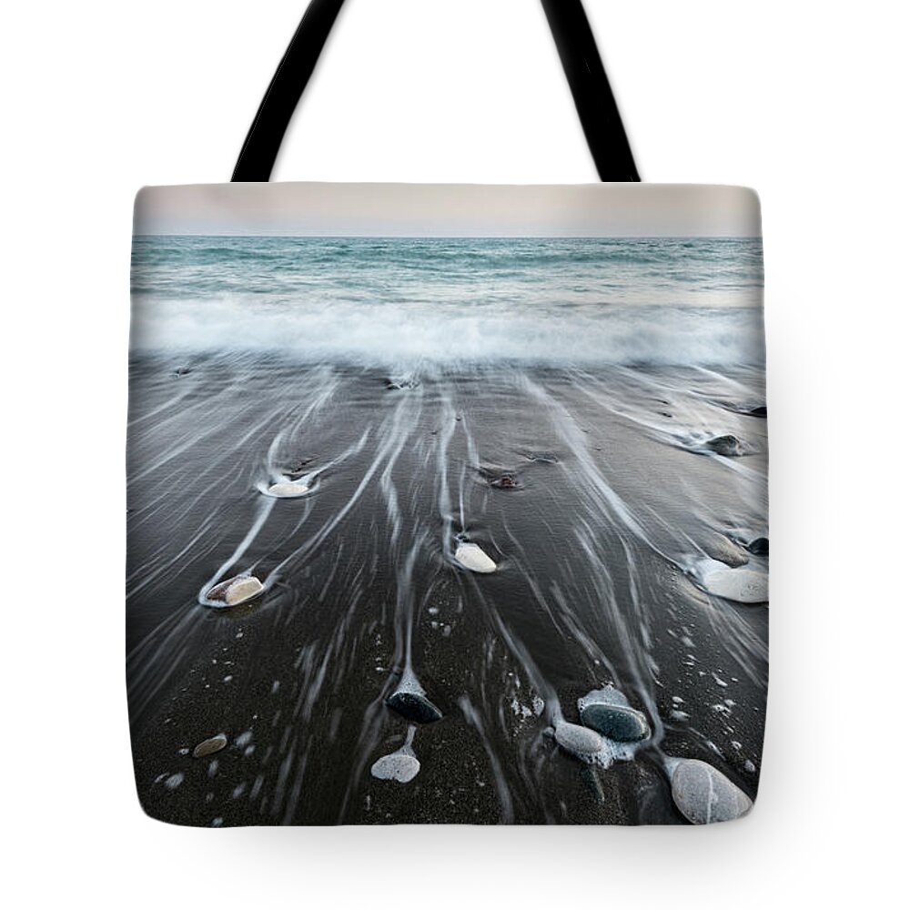 Seascape Tote Bag featuring the photograph Pebbles in the beach and flowing sea water by Michalakis Ppalis