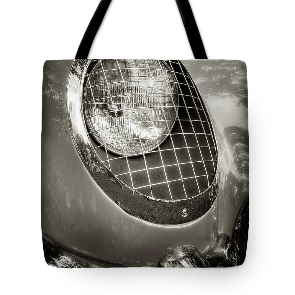 1955 Corvette Tote Bag featuring the photograph 55 Vette Headlight by Arttography LLC