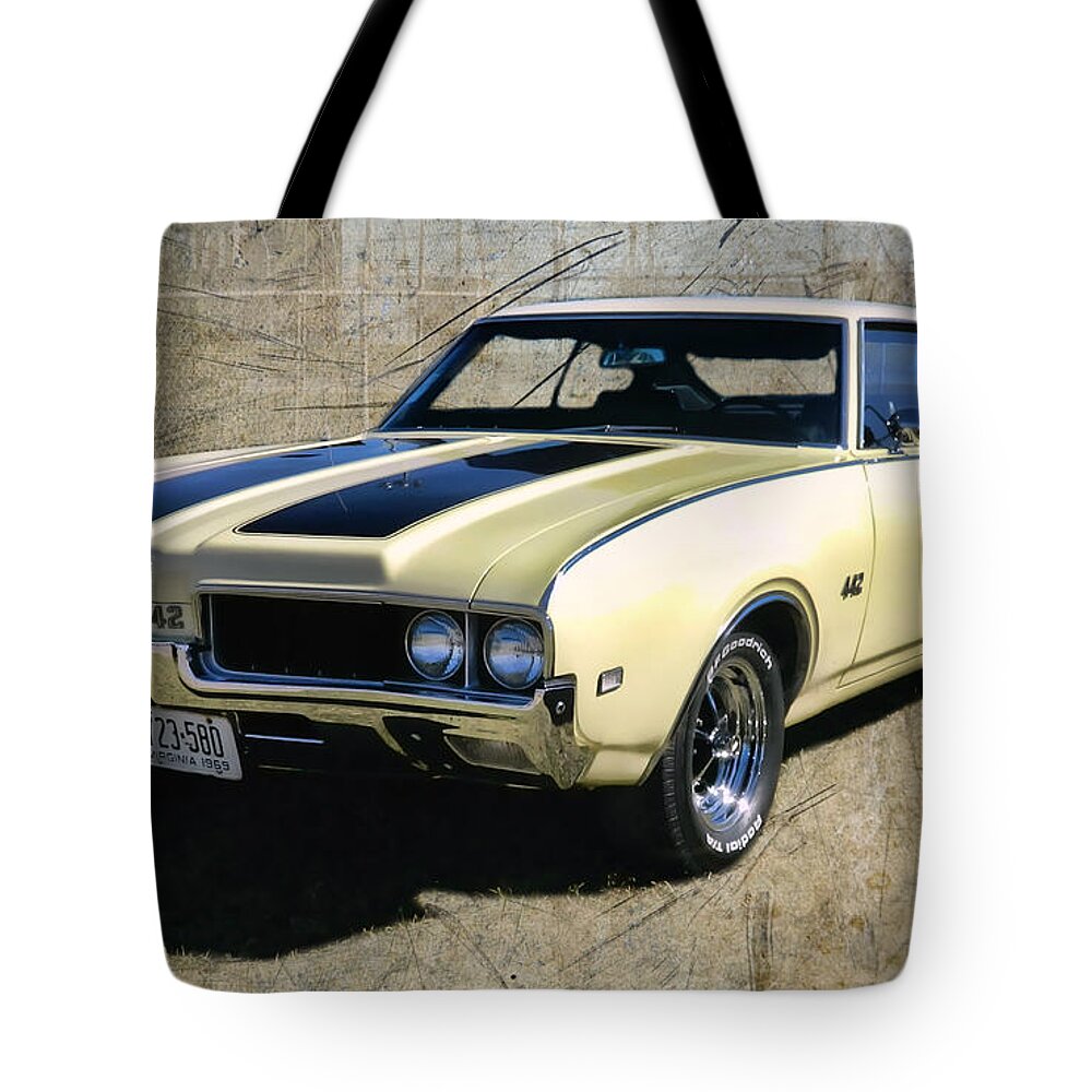 Victor Montgomery Tote Bag featuring the photograph '69 Oldsmobile 442 #69 by Vic Montgomery