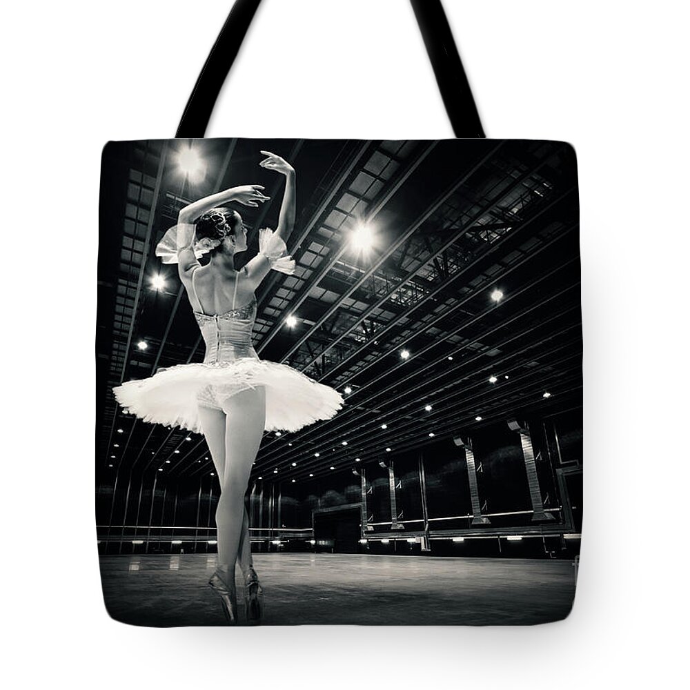 Ballet Tote Bag featuring the photograph A beautiful ballerina dancing in studio by Dimitar Hristov