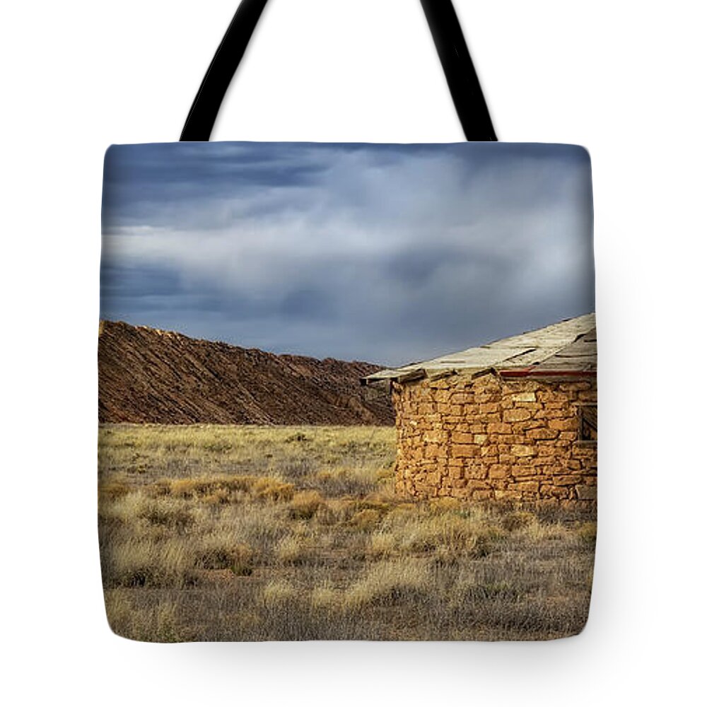 Navajo Tote Bag featuring the photograph A Hogan And Hogback Mountain by Jaime Miller