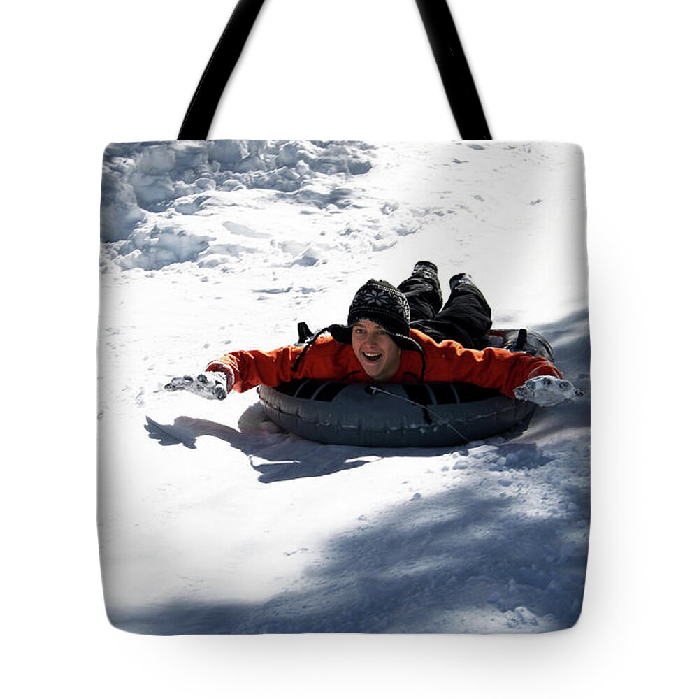 Winter Tote Bag featuring the photograph A Man Tubing, Flagstaff, Arizona, USA by Derrick Neill