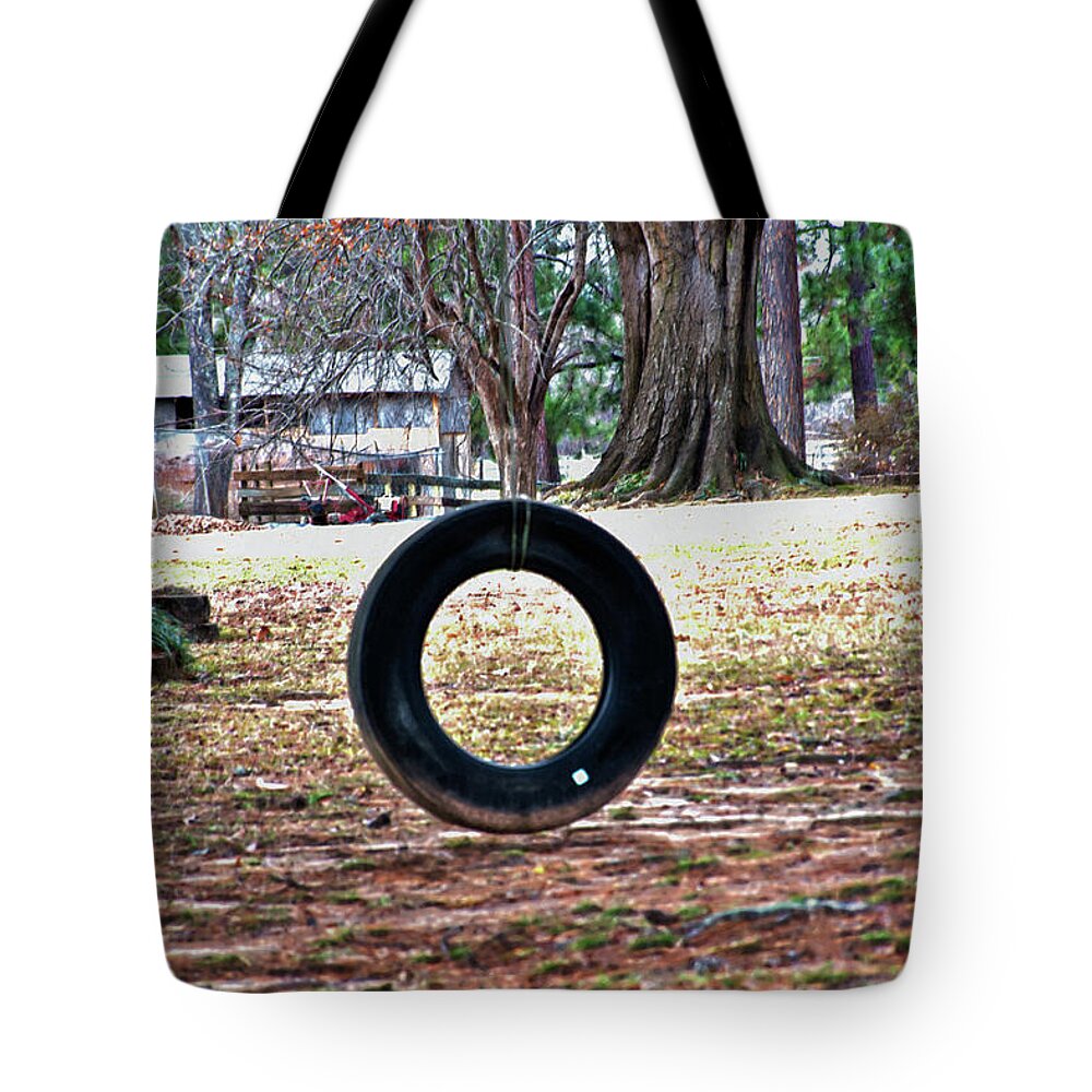 Tire Swing Tote Bag featuring the photograph A Tire Swing by Gina O'Brien