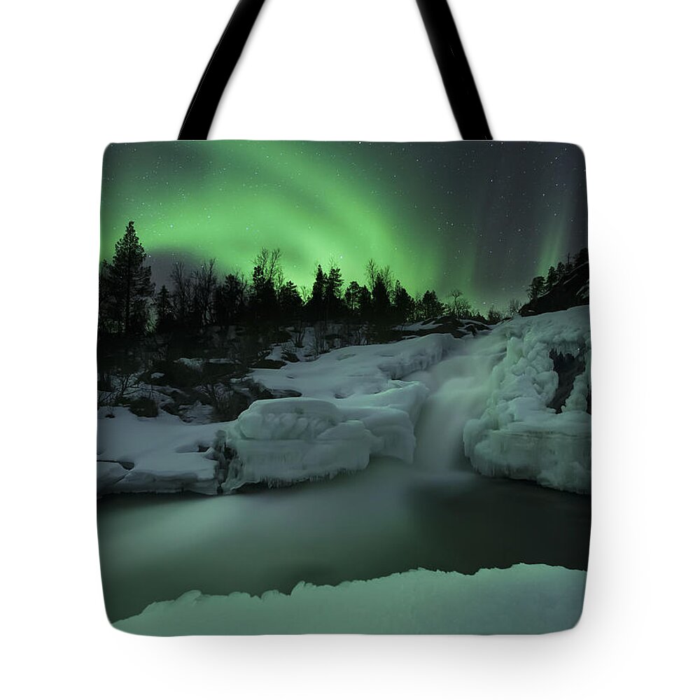 Green Tote Bag featuring the photograph A Wintery Waterfall And Aurora Borealis by Arild Heitmann