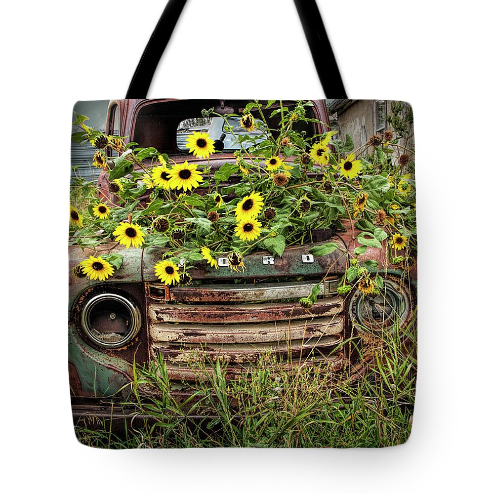Art Tote Bag featuring the photograph Abandoned Old Ford Truck with Yellow Flowers in the Ghost Town by Okaton South Dakota by Randall Nyhof