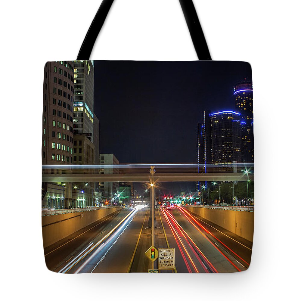 Detroit Tote Bag featuring the photograph Above Jefferson Avenue at night. by Jay Smith