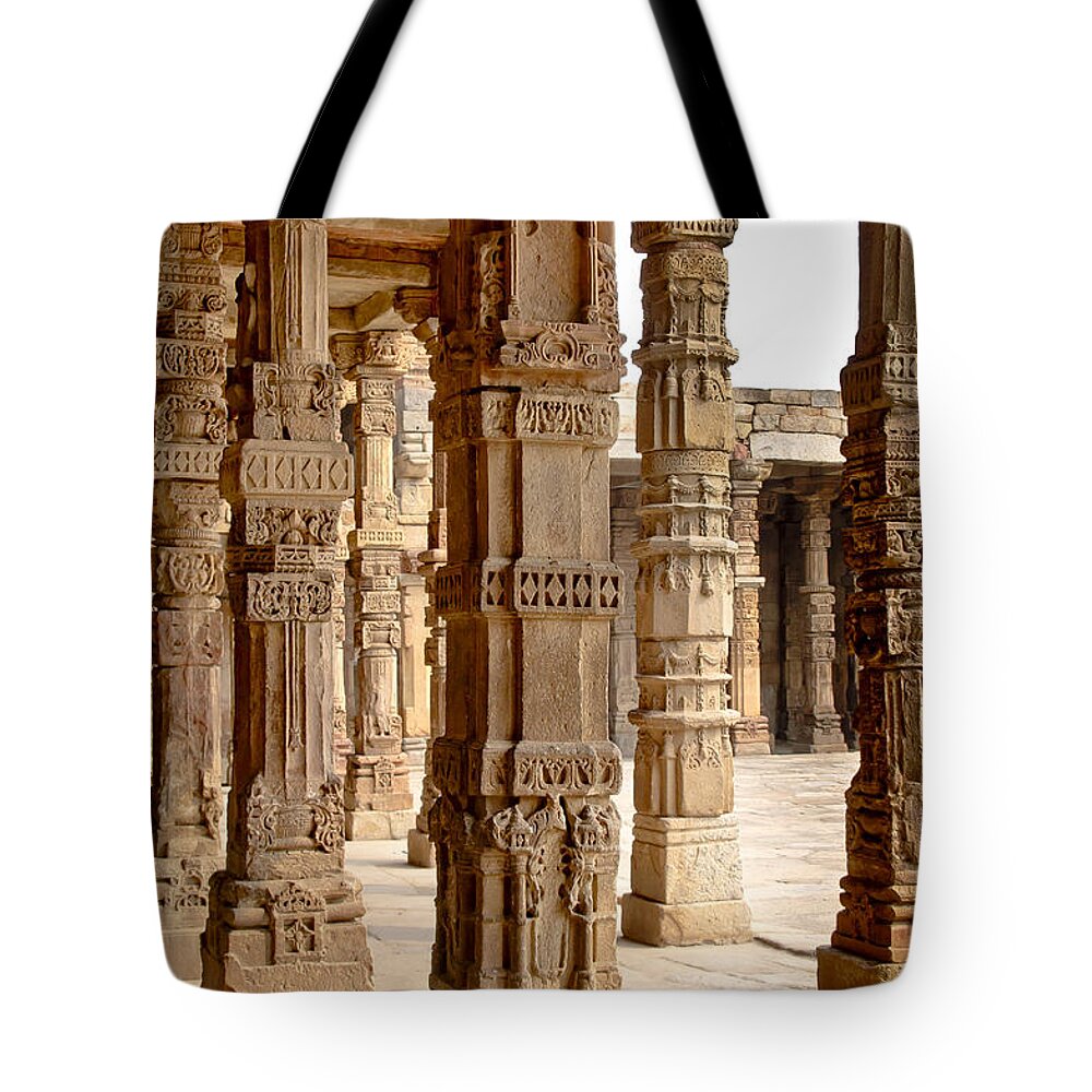 Pillars Tote Bag featuring the photograph Among pillars at Qutb Minar. by Elena Perelman