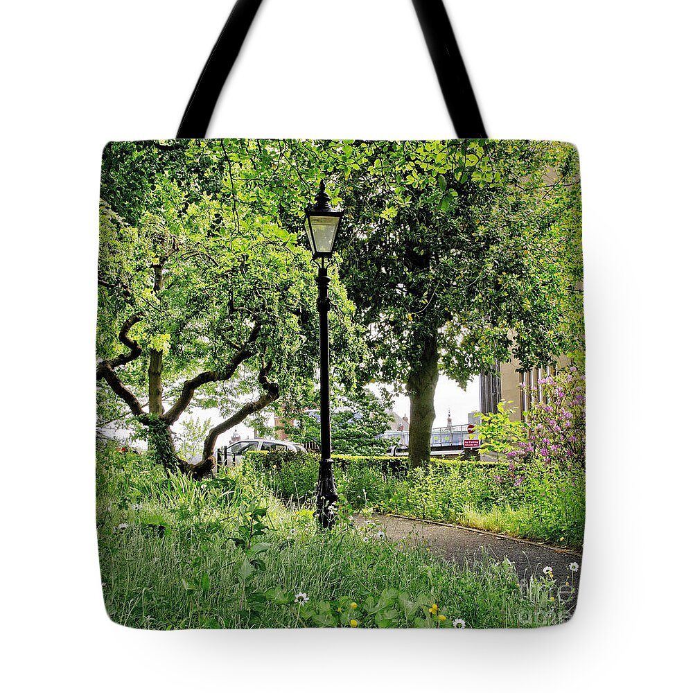Lamppost Tote Bag featuring the photograph Among trees and bushes. by Elena Perelman