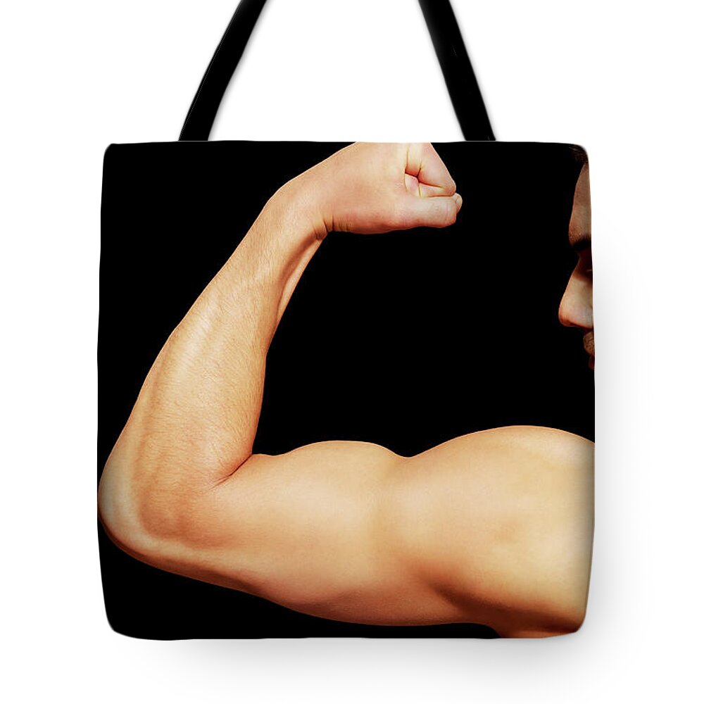 Man Tote Bag featuring the photograph Back view of young muscular man by Piotr Marcinski