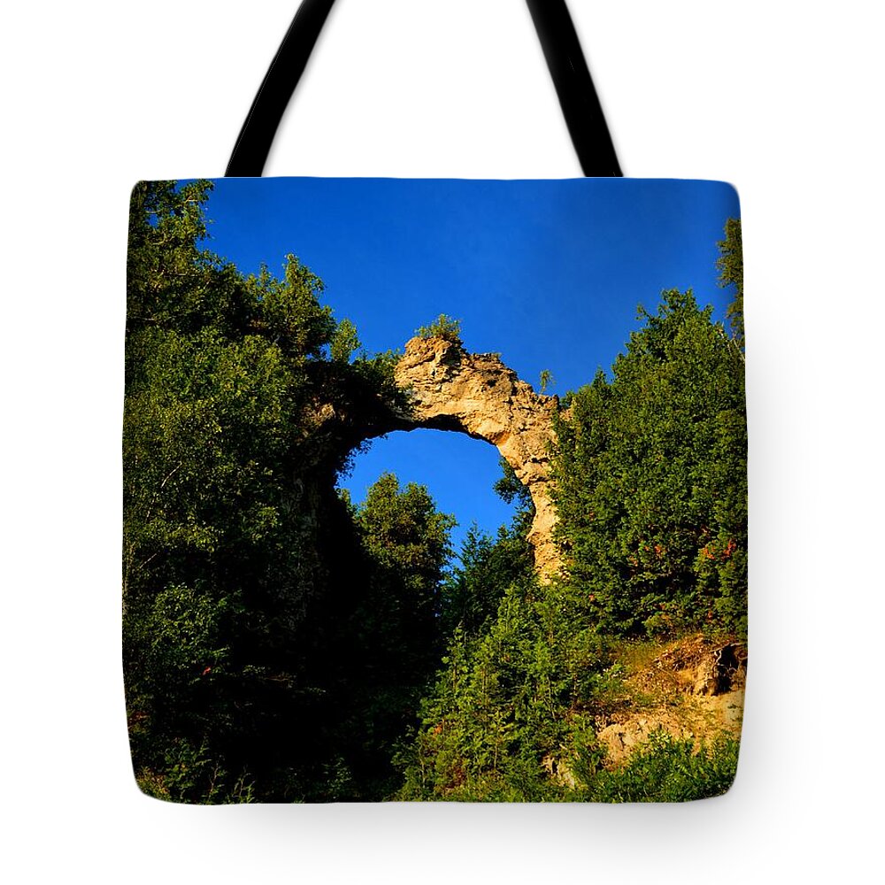 Mackinac Island Tote Bag featuring the photograph Beneath Arch Rock by Keith Stokes