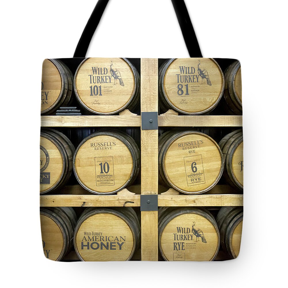 American Tote Bag featuring the photograph Barrels of Wild Turkey Bourbon in distillery by Karen Foley
