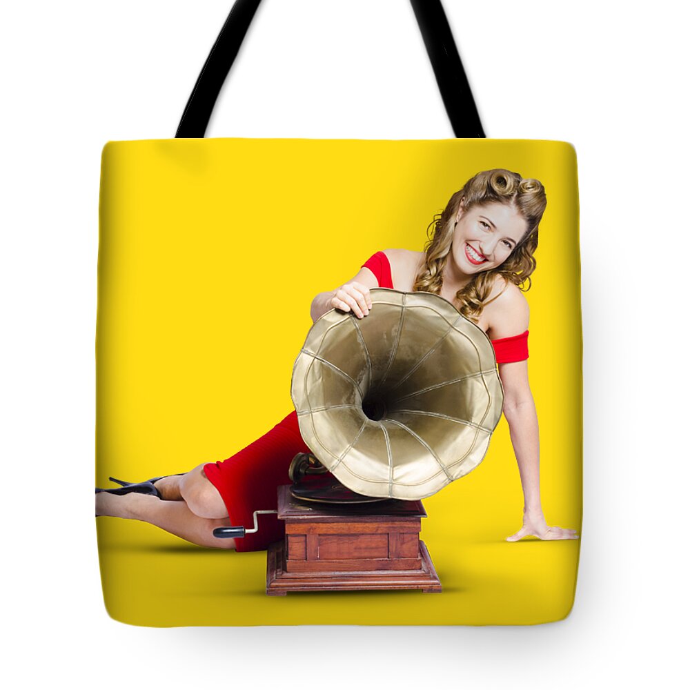 Music Tote Bag featuring the photograph Beautiful pinup woman listening to old gramophone by Jorgo Photography