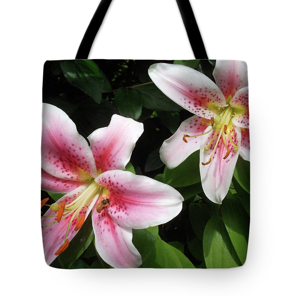 Honey Bee Tote Bag featuring the photograph Bee in the Lilies by Susan Esbensen