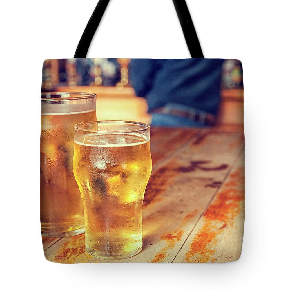 Alcohol Tote Bag featuring the photograph Beers in a pub by Patricia Hofmeester