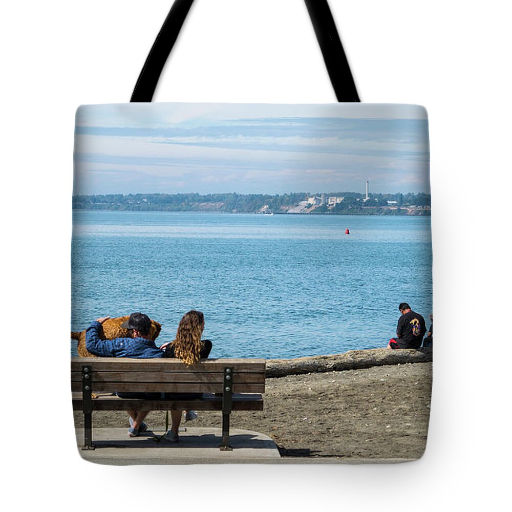 Bench And Log In Boulevard Park Tote Bag featuring the photograph Bench and Log in Boulevard Park by Tom Cochran