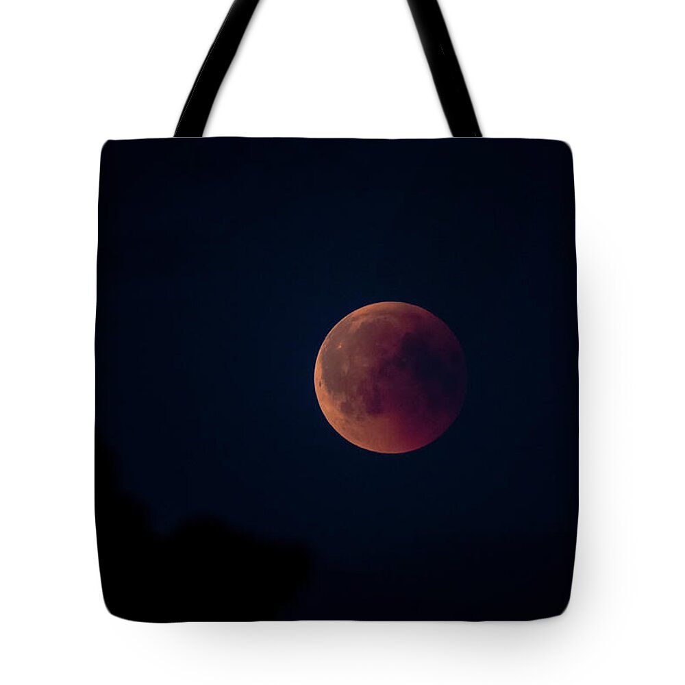 Blood Moon Tote Bag featuring the photograph Blood Moon by Torbjorn Swenelius