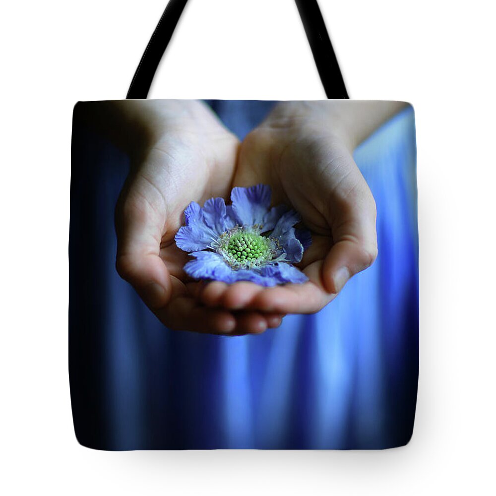 Blue Flower Tote Bag featuring the photograph Blue flower in little girl's hands by Maggie Mccall