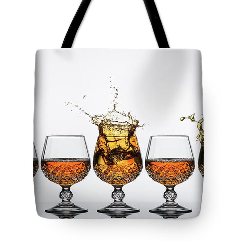 Alcohol Tote Bag featuring the photograph Brandy Glass Splash by Andy Astbury