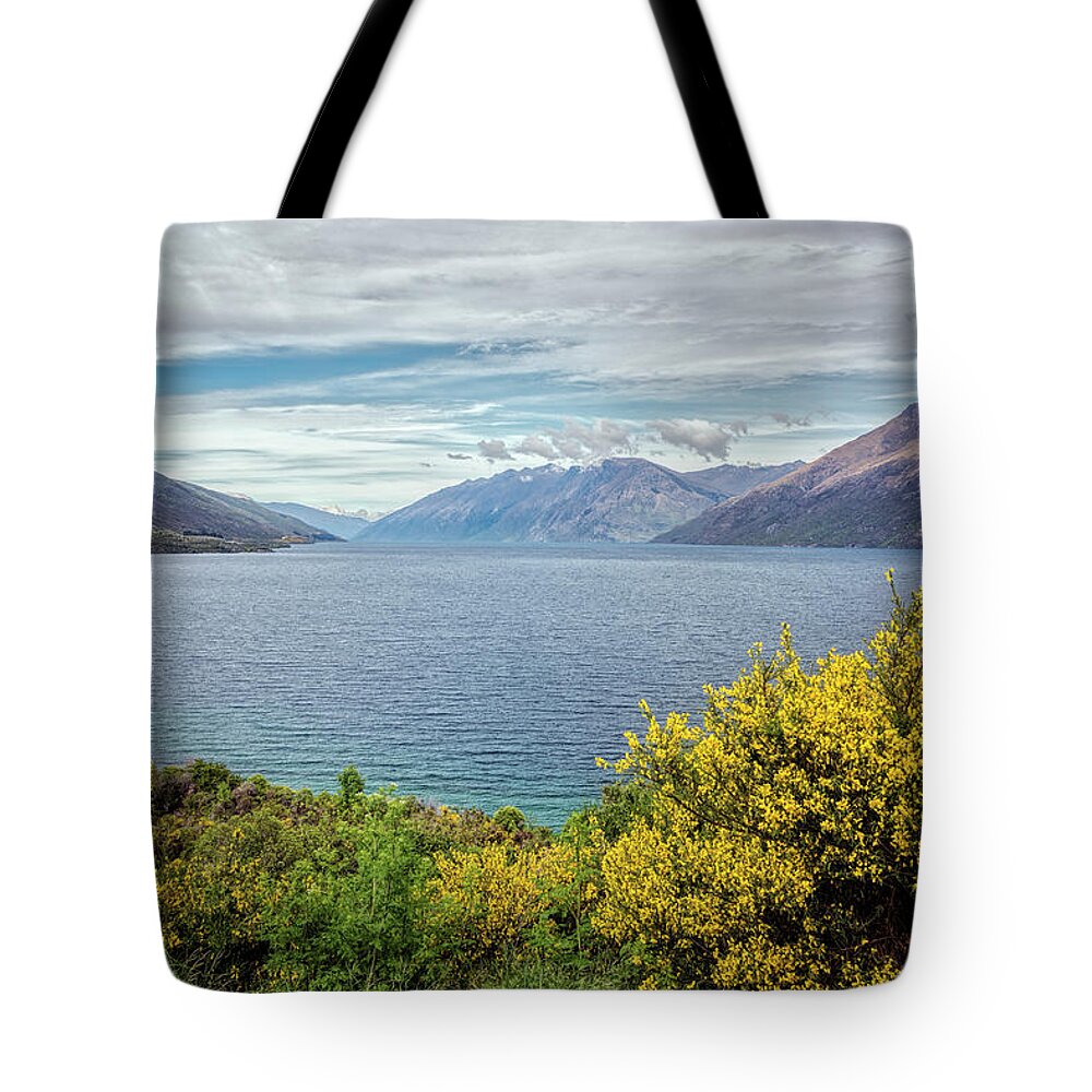 Joan Carroll Tote Bag featuring the photograph Broom Bushes on Lake Wakatipu New Zealand by Joan Carroll