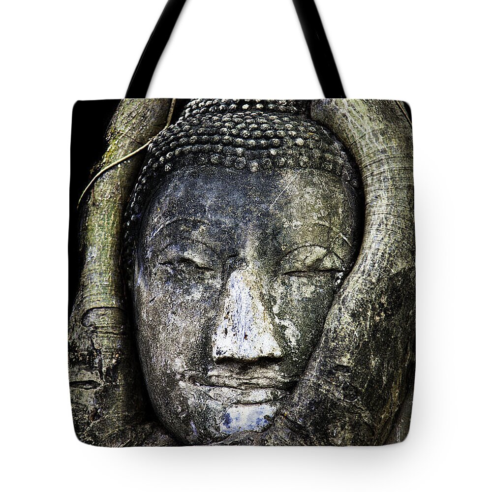 Buddha Head Tote Bag featuring the photograph Buddha Head in Banyan Tree by Adrian Evans