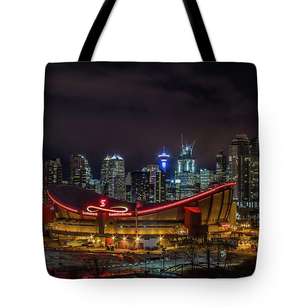 Calgary Tote Bag featuring the photograph Calgary and the Saddledome at night by Jay Smith