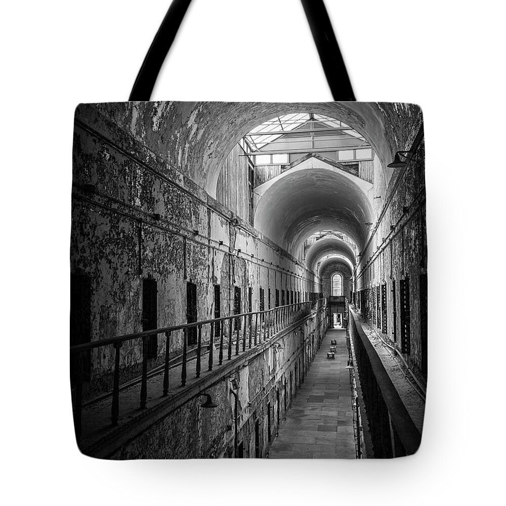Eastern State Penitentiary Tote Bag featuring the photograph Cellblock 7 In Black And White by Tom Singleton