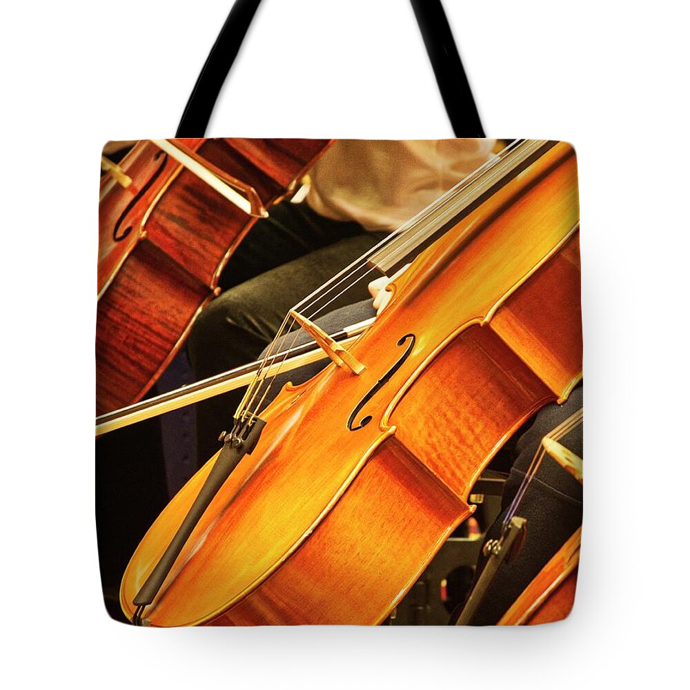 A Row Of Cellos At A Recent Suzuki Music Workshop In Madison Tote Bag featuring the photograph Cellos by Steven Ralser