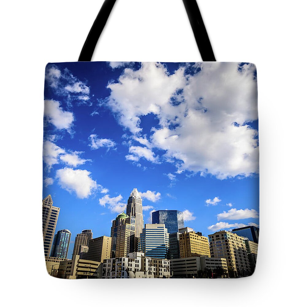 121 West Trade Tote Bag featuring the photograph Charlotte Skyline Blue Sky and Clouds by Paul Velgos
