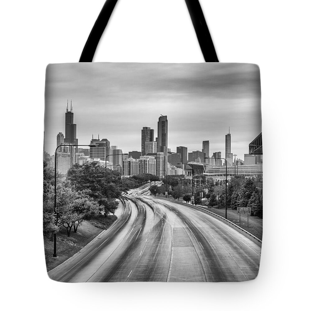 Windy Tote Bag featuring the photograph Chicago Skyline in Black and White from the McCormick Place Pedestrian Bridge over Lake Shore Drive by Silvio Ligutti