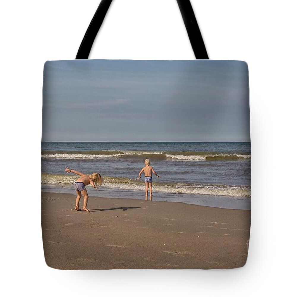 Active Tote Bag featuring the photograph Children playing at the sea shore by Patricia Hofmeester