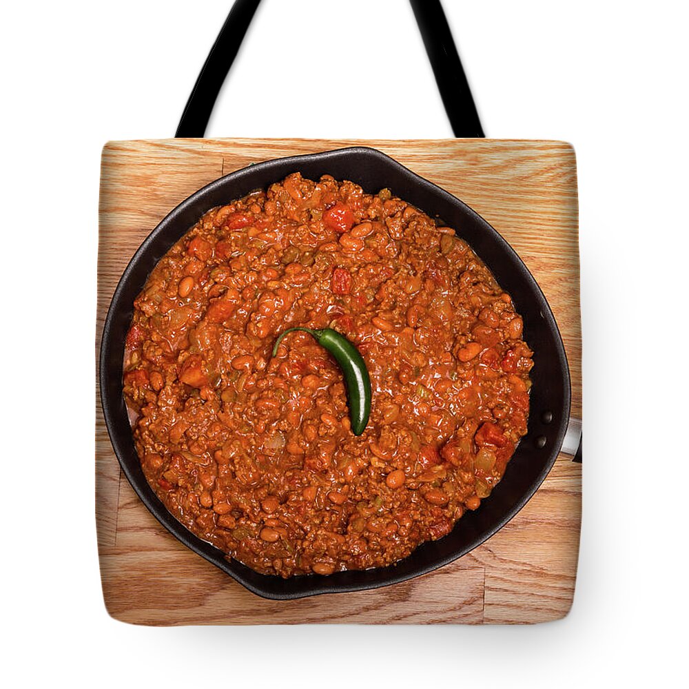 Beans Tote Bag featuring the photograph Chili in Black Pan on Wood Table with Jalapeno Pepper by Darryl Brooks