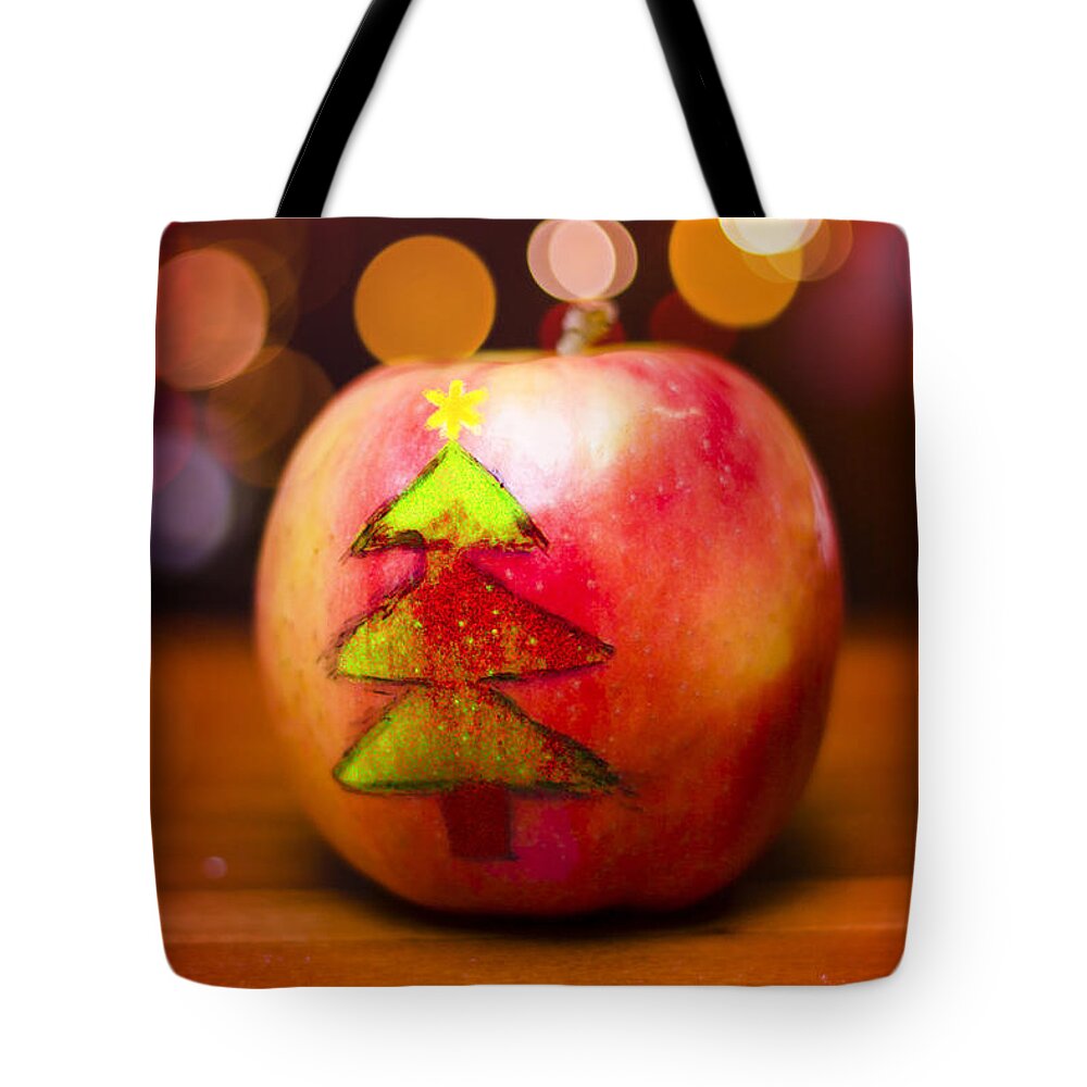 Christmas Tote Bag featuring the photograph Christmas tree painted on apple decoration by Jorgo Photography