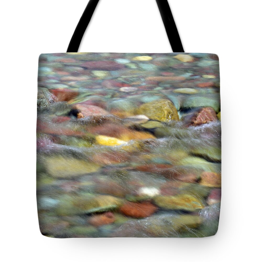 Glacier Tote Bag featuring the photograph Colorful Rocks in Two Medicine River in Glacier National Park by Bruce Gourley