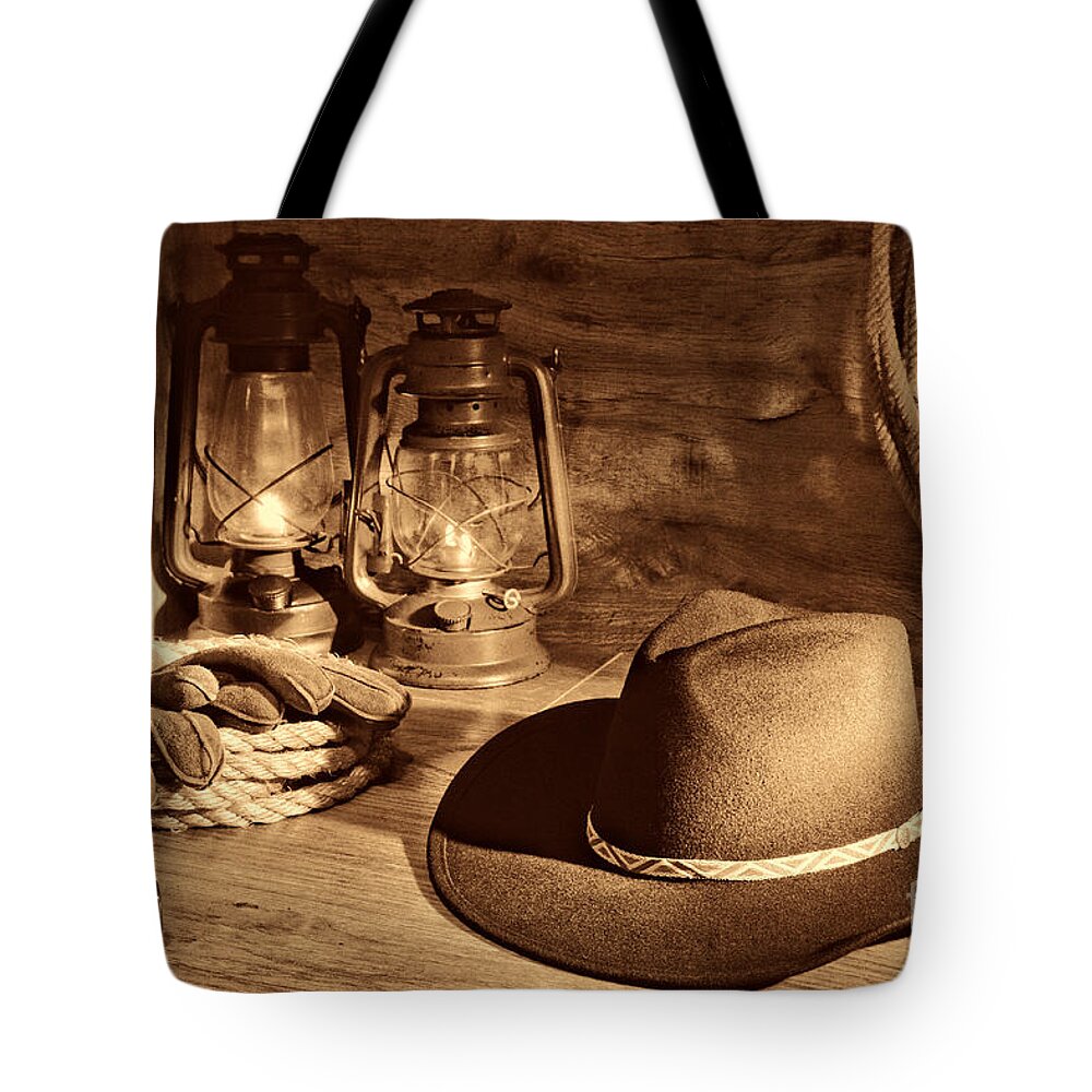 Western Tote Bag featuring the photograph Cowboy Hat and Kerosene Lanterns by American West Legend By Olivier Le Queinec