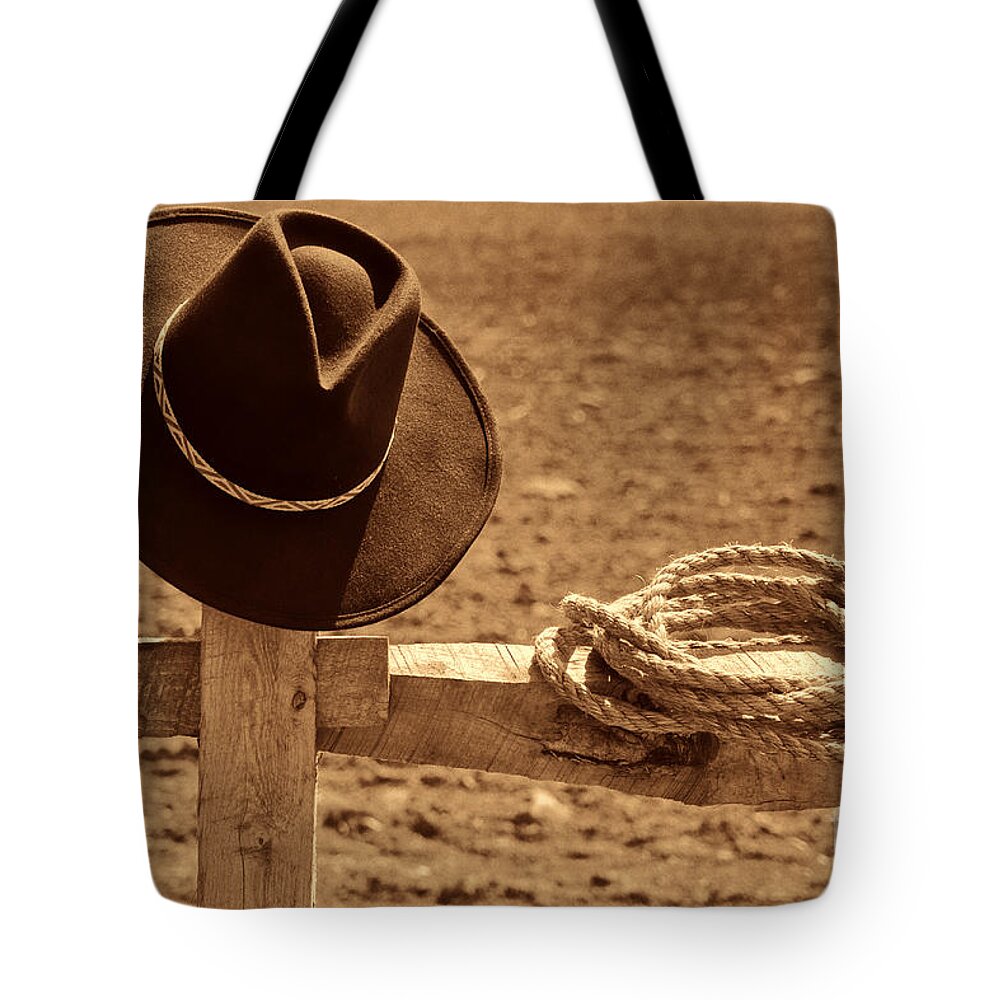 Western Tote Bag featuring the photograph Cowboy Hat and Rope on a Fence by American West Legend By Olivier Le Queinec