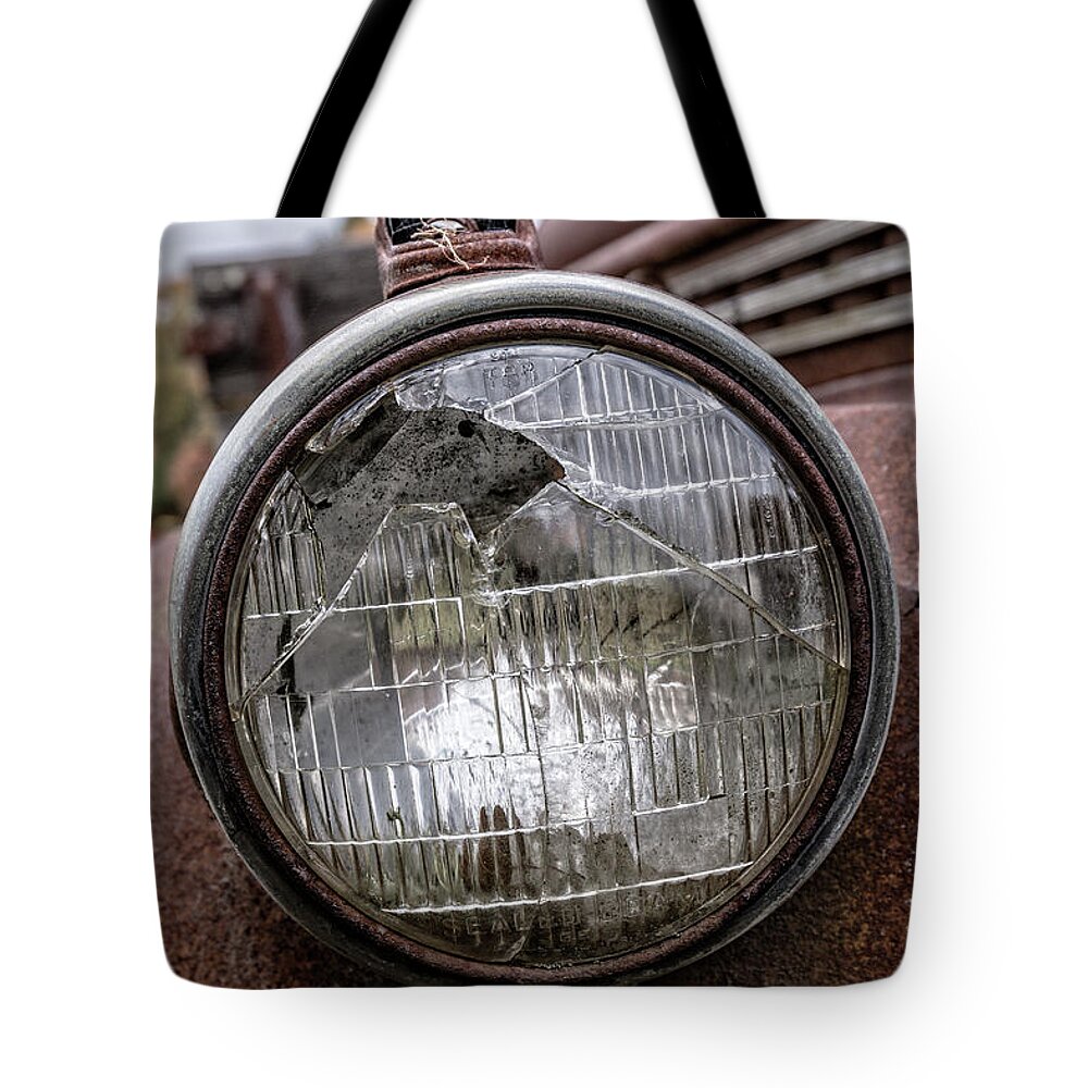 Glass Tote Bag featuring the photograph Cracked Headlight on an old truck by Edward Fielding
