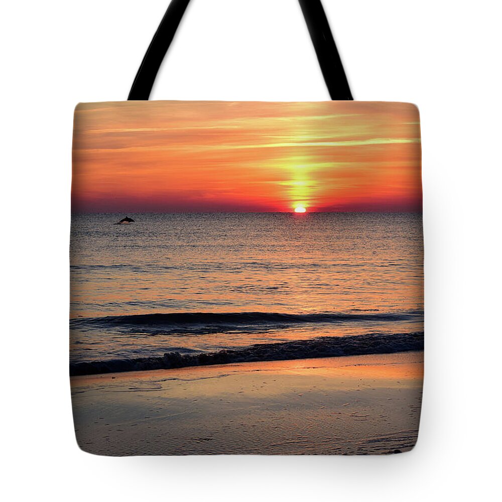 Dolphin Tote Bag featuring the photograph Dolphin Jumping in the Sunrise by Nicole Lloyd