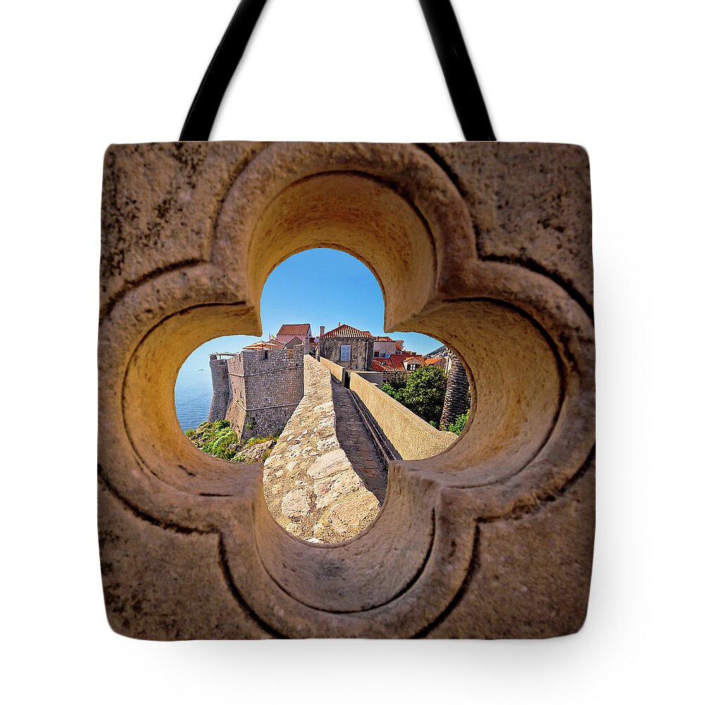 Dubrovnik Tote Bag featuring the photograph Dubrovnik city walls view through stone carved detail by Brch Photography