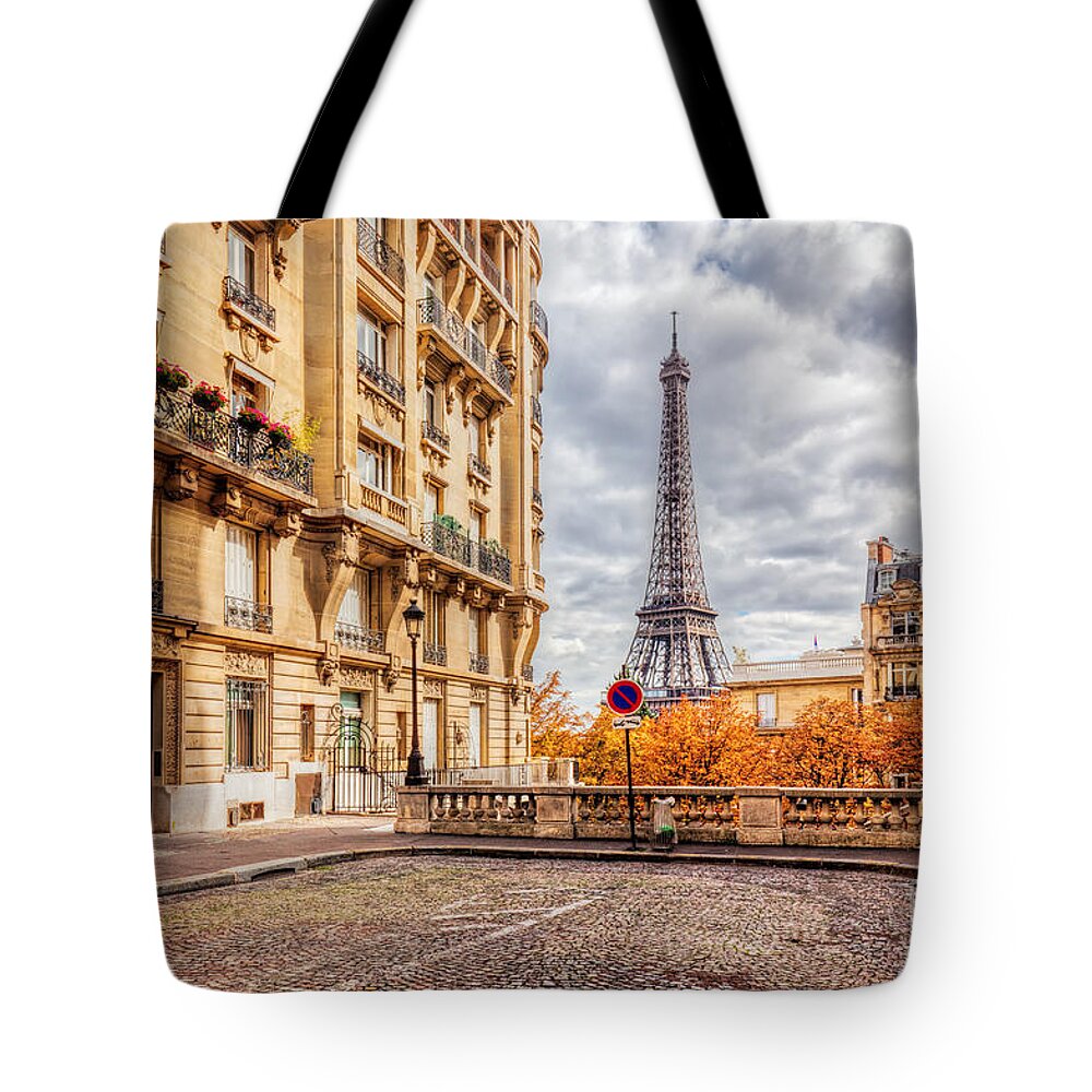 Paris Tote Bag featuring the photograph Eiffel Tower seen from the street in Paris, France. Cobblestone pavement by Michal Bednarek