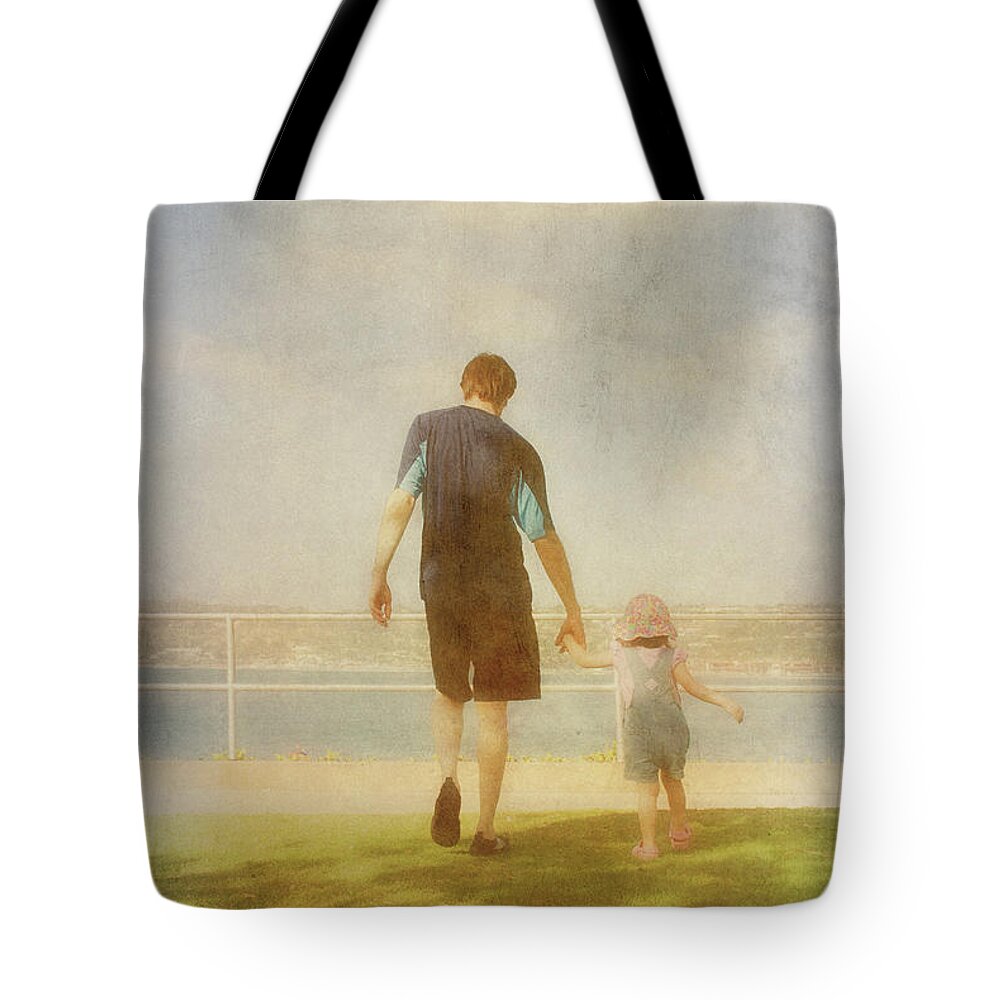 Father And Daughter Holding Hands Tote Bag featuring the photograph Father and Daughter holding hands by Claudia Ellis by Claudia Ellis