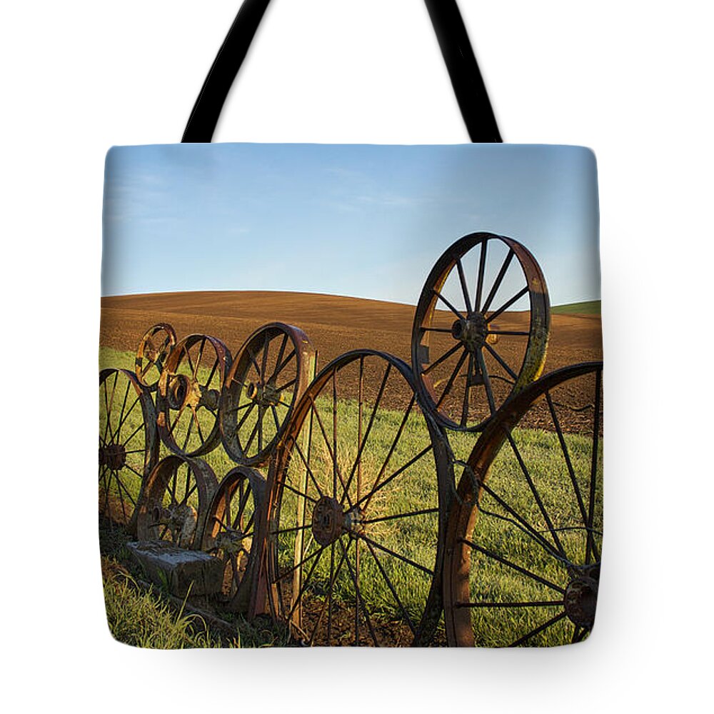 Palouse Tote Bag featuring the photograph Fence of Wheels by Mary Lee Dereske