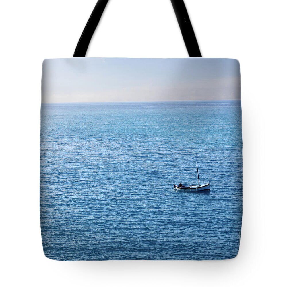 Fisherman in Small Boat Land on Horizon Tote Bag by SAJE