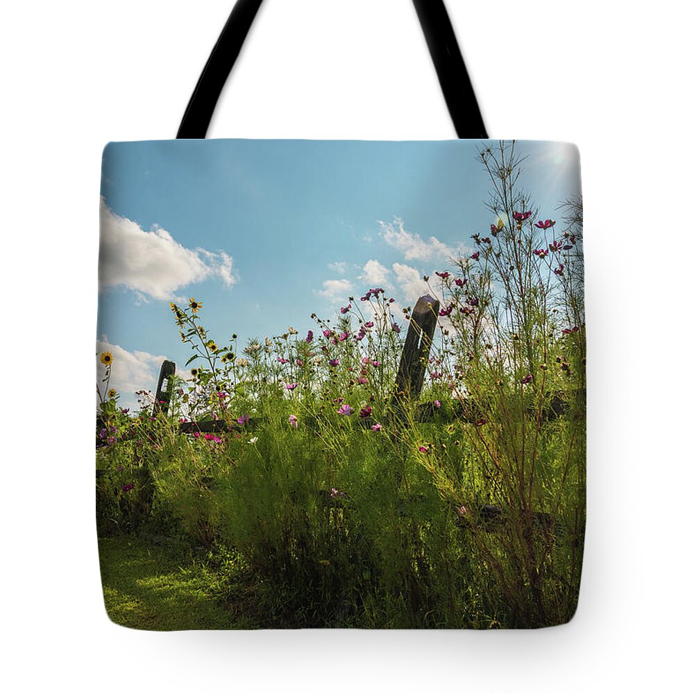 Flower Tote Bag featuring the photograph Flowers and Fences by Kristopher Schoenleber