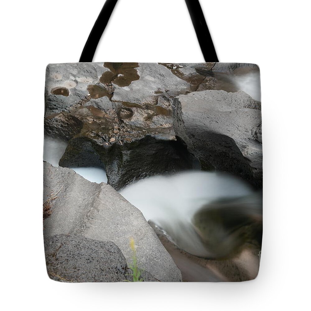 Creaks Tote Bag featuring the photograph Flowing in between ancient rock by Jeff Swan