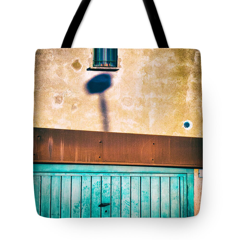 Abstract Tote Bag featuring the photograph Garage door with window and shadow by Silvia Ganora