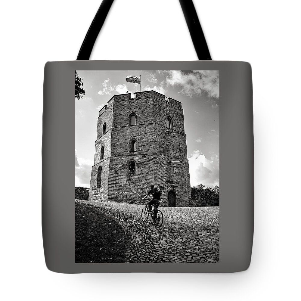 Gediminas Tote Bag featuring the photograph Gediminas Tower and Bicycler Lithuania by Mary Lee Dereske