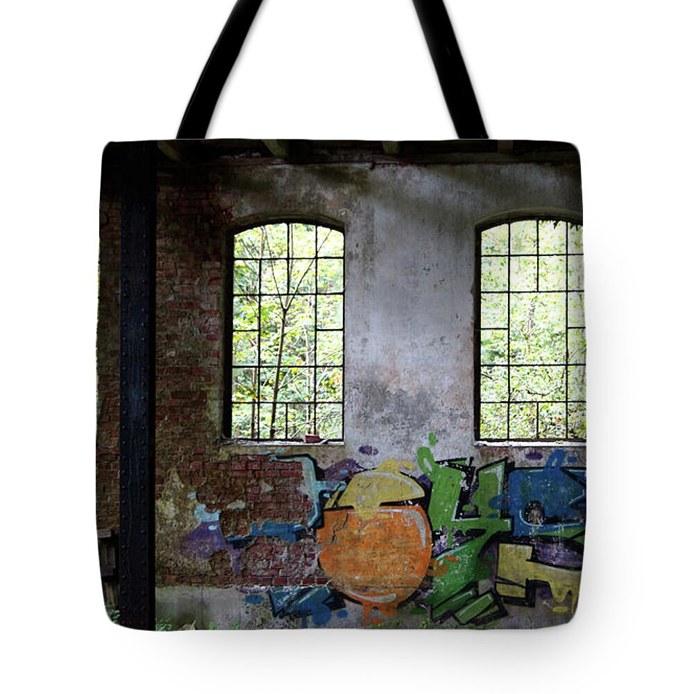 Factory Tote Bag featuring the photograph Graffiti on the walls of an old factory by Eva-Maria Di Bella