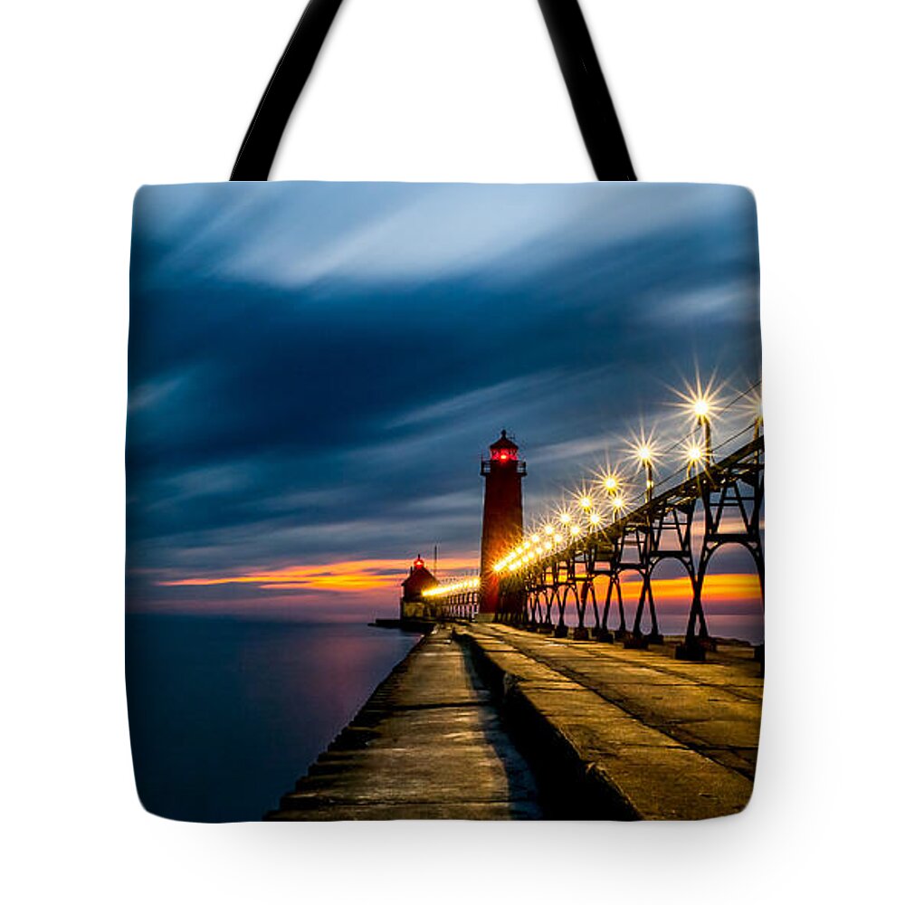 Grand Haven Tote Bag featuring the photograph Grand Haven Lighthouse by Larry Carr