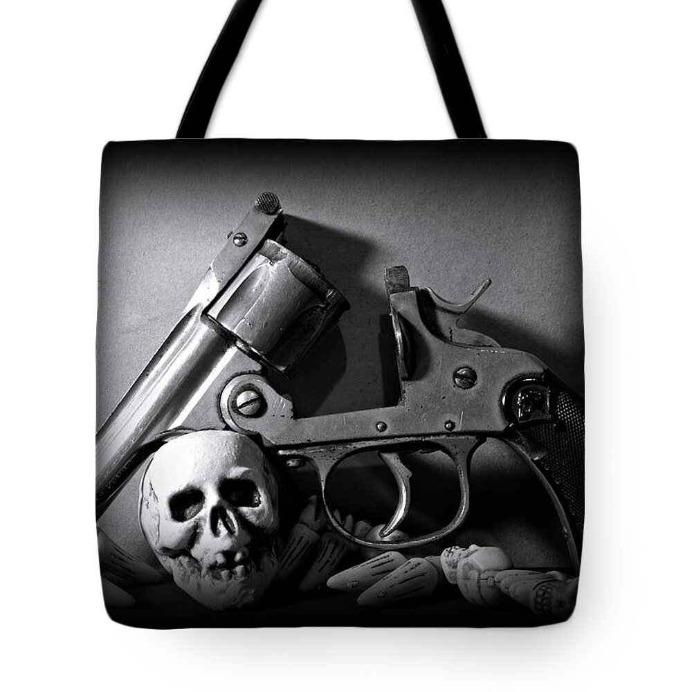 Black And White Tote Bag featuring the photograph Gun and Skull by Scott Wyatt